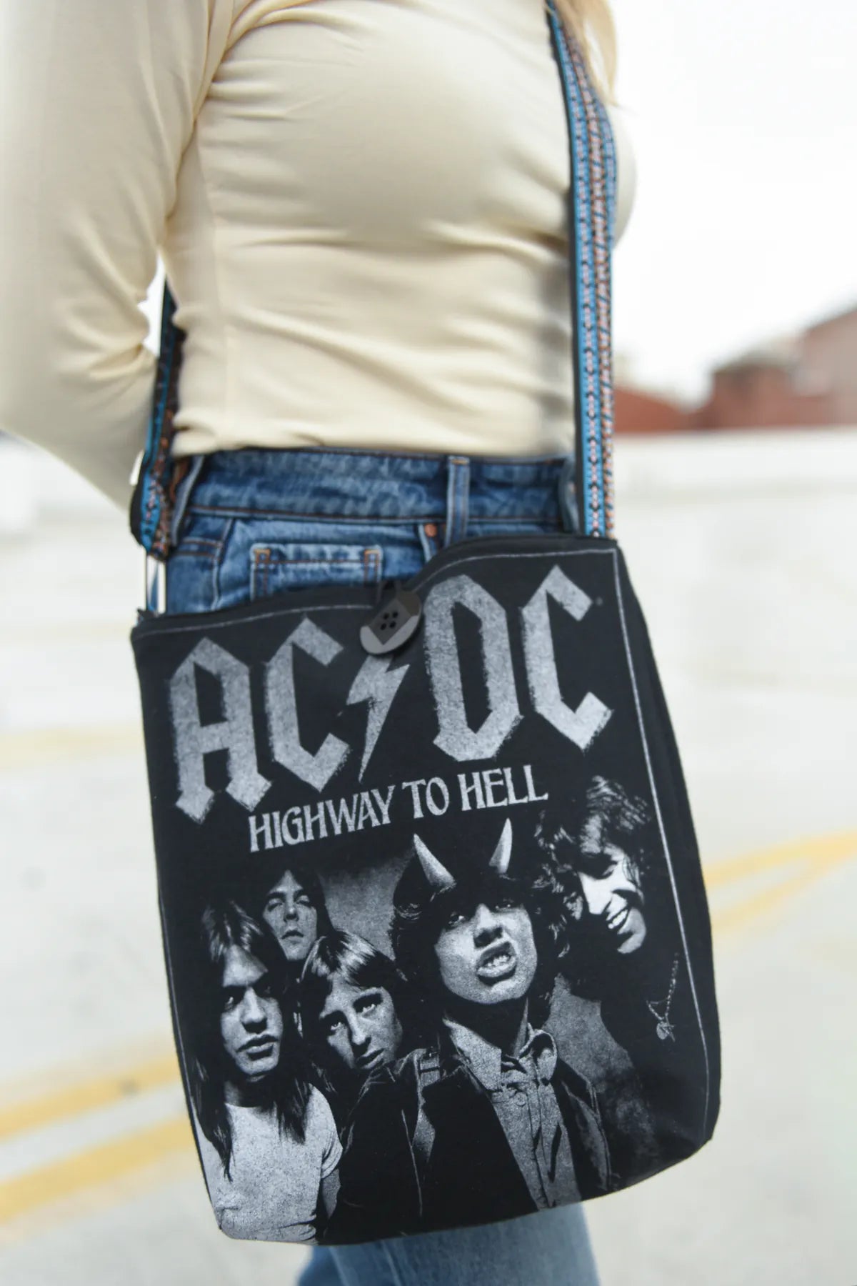 Hero image of the upcycled concert tee graphic side of a handmade reversible Switch Purse bag