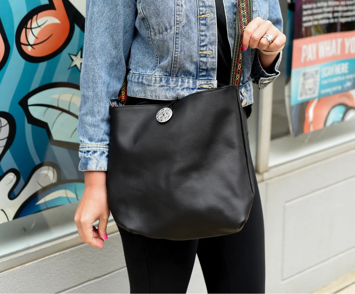 Black side of a handmade reversible messenger bag styled as the second everyday look