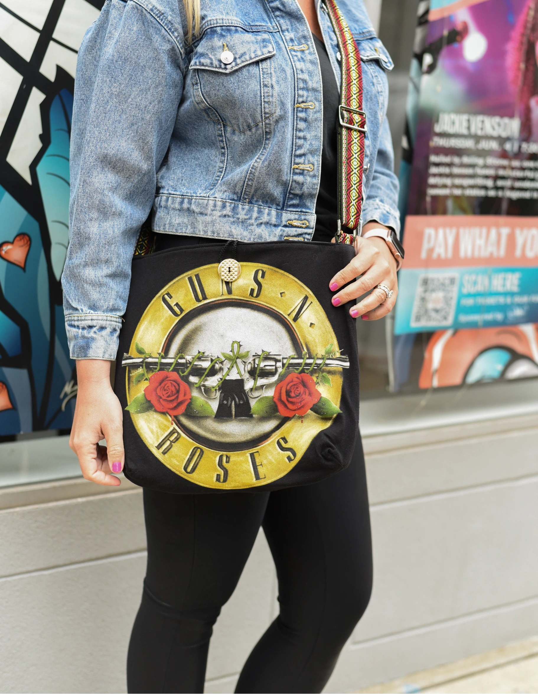 Product view of a handmade reversible messenger bag made from an upcycled concert tee
