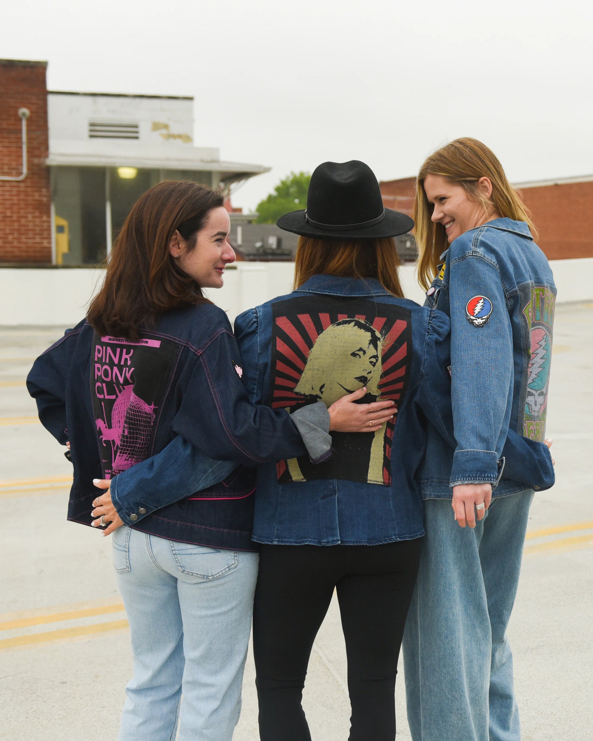 Lifestyle portrait of an upcycled denim jacket styled with handmade Switch Purse pieces